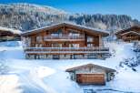 Experience the ultimate winter escape in this stunning chalet nestled amidst a snowy landscape.
