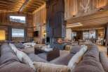 Experience luxury living in this stunning chalet, featuring a grand fireplace and exquisite wooden accents throughout.