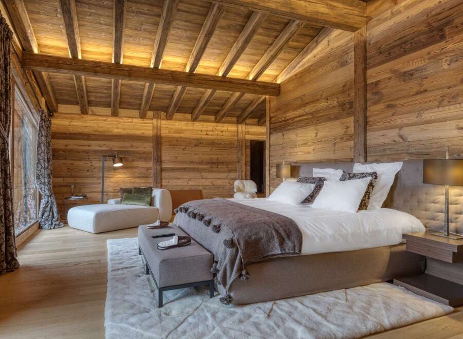 Experience rustic luxury in this stunning wooden bedroom.