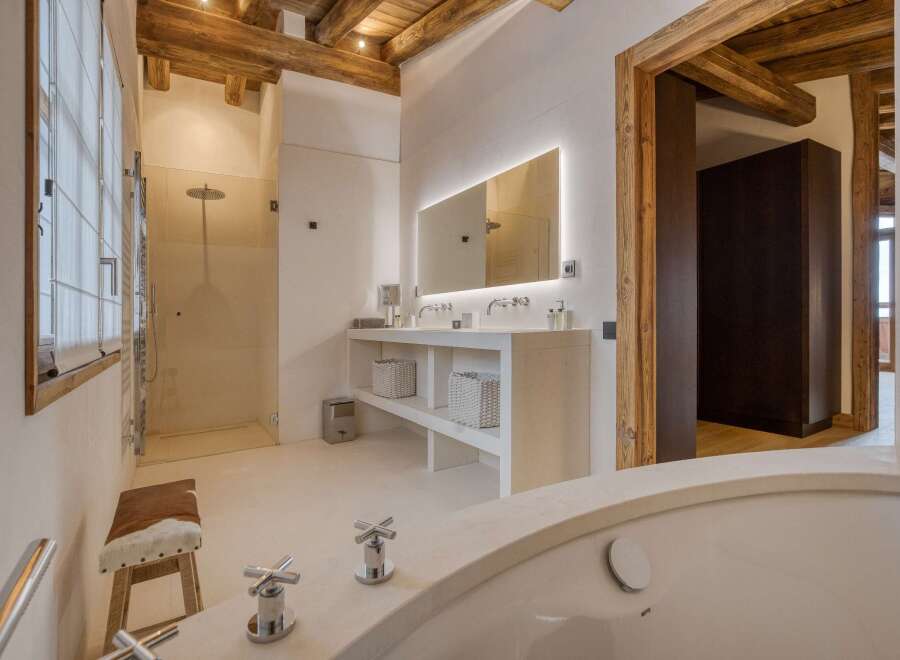 This luxurious bathroom boasts a spa-like ambiance with its sleek design and high-end finishes.