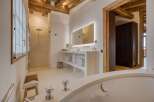 This luxurious bathroom boasts a spa-like ambiance with its sleek design and high-end finishes.