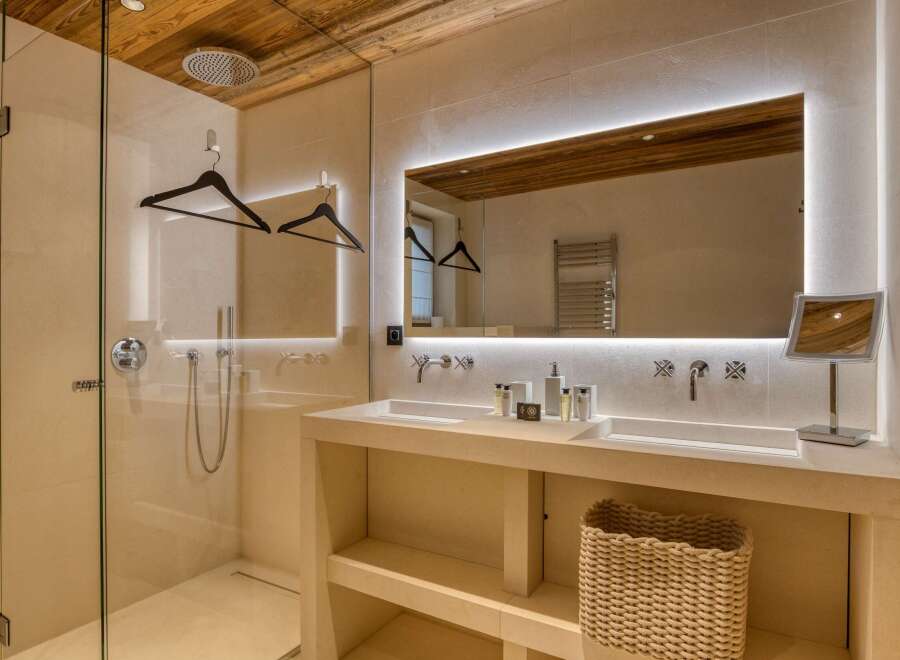 Indulge in the luxurious ambiance of this stunning bathroom, featuring a sleek design and modern amenities.