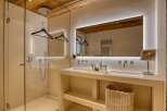 Indulge in the luxurious ambiance of this stunning bathroom, featuring a sleek design and modern amenities.