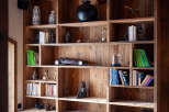 This stunning property boasts a custom-built wooden bookshelf, adding a touch of rustic elegance to the space.