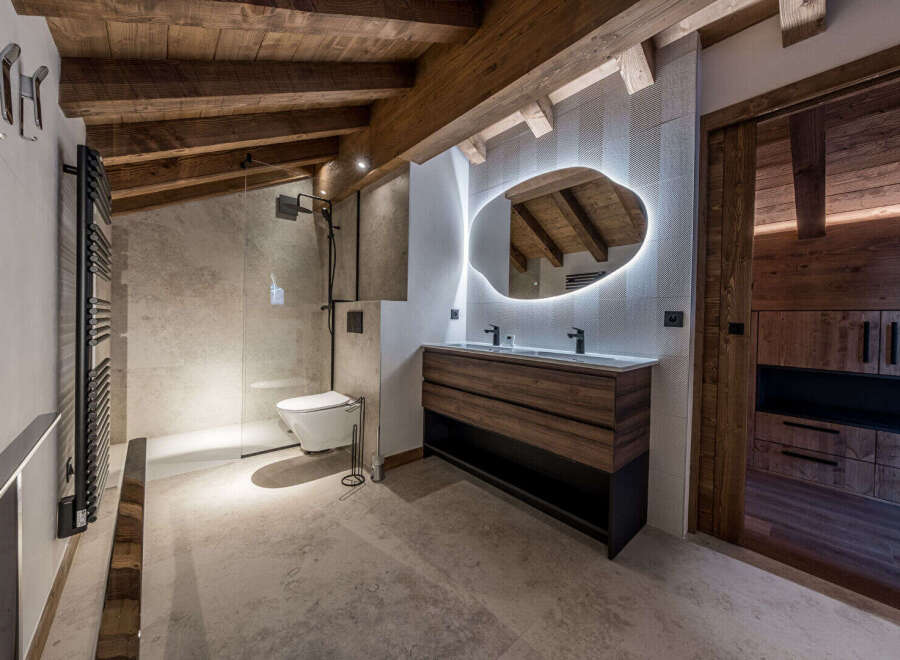 Experience luxury in this stunning bathroom, featuring a modern design with rustic wooden accents.