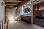 Experience luxury in this stunning bathroom, featuring a modern design with rustic wooden accents.