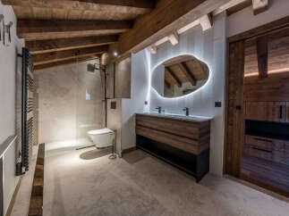 Experience luxury in this stunning bathroom, featuring a modern design with rustic wooden accents.