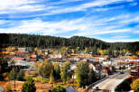 Nestled in a valley surrounded by lush forests, this charming town boasts a picturesque setting.