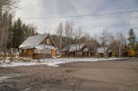 Rustic wooden cabins nestled in a snowy forest setting, offering a charming and peaceful getaway.