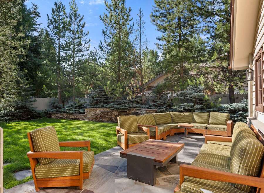 This stunning property boasts a spacious backyard with a beautifully landscaped lawn, providing a serene and private outdoor oasis.