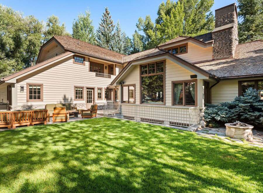 This stunning property boasts a spacious backyard with lush green grass, perfect for outdoor entertaining.