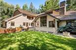 This stunning property boasts a spacious backyard with lush green grass, perfect for outdoor entertaining.