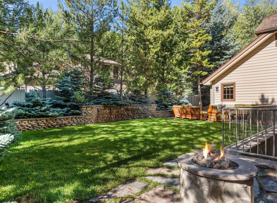 This stunning property boasts a spacious backyard with lush green grass, perfect for outdoor entertaining.