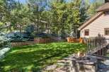 This stunning property boasts a spacious backyard with lush green grass, perfect for outdoor entertaining.