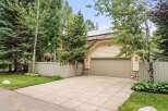 This charming home boasts a spacious driveway, a large garage, and a well-maintained lawn.