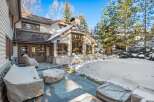 This stunning property boasts a spacious patio perfect for outdoor entertaining, complete with a stone fire pit and comfortable seating areas.