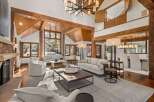 This stunning property boasts a spacious, open-plan living area with soaring ceilings and exposed wooden beams, creating a warm and inviting atmosphere.