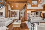 This stunning living room boasts a vaulted ceiling with exposed wooden beams, creating a warm and inviting atmosphere.