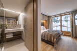 This stunning bedroom boasts a cozy atmosphere with its wooden features and a luxurious faux fur throw.