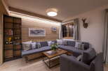 Cozy living room with built-in wooden shelving and a comfortable sectional sofa.
