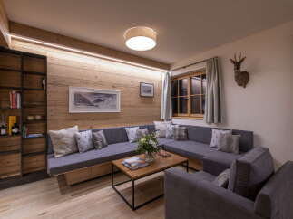 Cozy living room with built-in wooden shelving and a comfortable sectional sofa.