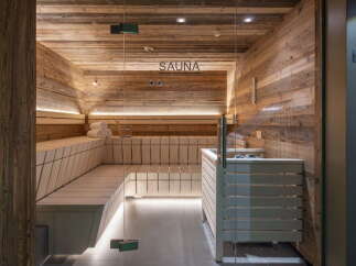 Indulge in tranquility within this exquisitely designed sauna, showcasing rustic wooden walls and sleek modern features.