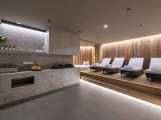 Relax and rejuvenate in our luxurious spa, featuring a tranquil relaxation area with comfortable loungers and a sleek, modern design.