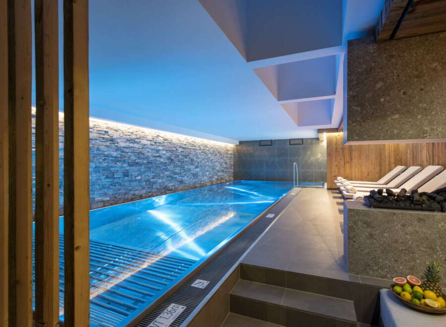 Indulge in tranquility at our luxurious hotel, featuring a stunning indoor pool bathed in soothing blue light.