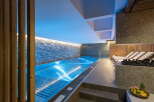 Indulge in tranquility at our luxurious hotel, featuring a stunning indoor pool bathed in soothing blue light.