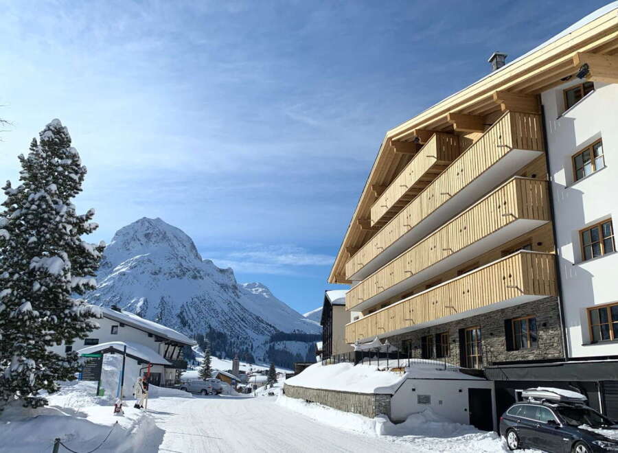 This stunning luxury apartment building boasts breathtaking mountain views and modern architecture.