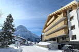 This stunning luxury apartment building boasts breathtaking mountain views and modern architecture.