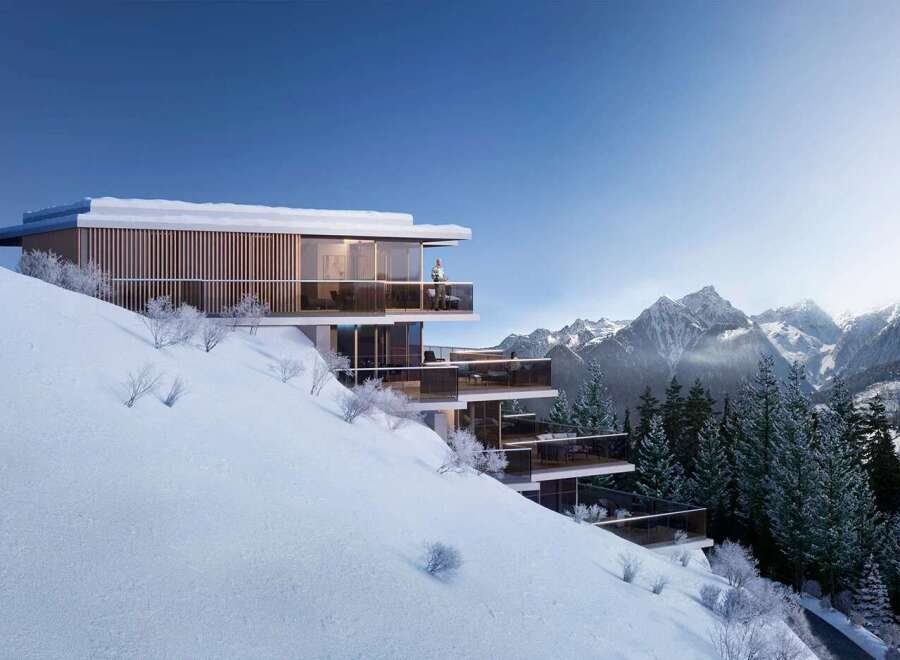 This stunning luxury chalet boasts breathtaking mountain views and a prime location on a snow-covered hillside.