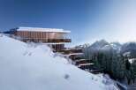 This stunning luxury chalet boasts breathtaking mountain views and a prime location on a snow-covered hillside.