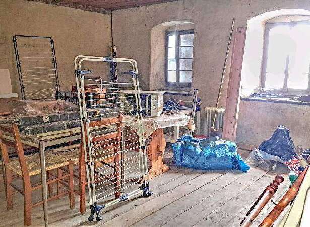 This property features a spacious room with ample natural light from large windows.