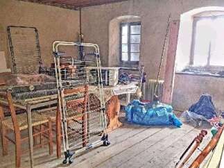 This property features a spacious room with ample natural light from large windows.
