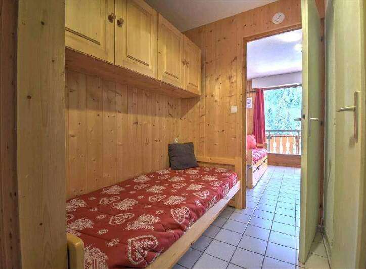 Cozy wooden cabin with built-in bunk beds and a balcony offering stunning views.