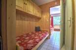 Cozy wooden cabin with built-in bunk beds and a balcony offering stunning views.