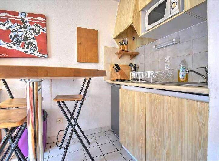 Cozy kitchen with wooden cabinets and a breakfast bar.