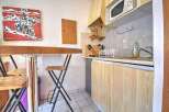 Cozy kitchen with wooden cabinets and a breakfast bar.