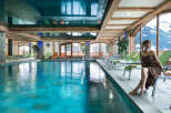 Relax and rejuvenate in our luxurious indoor pool area, complete with comfortable lounge chairs and stunning mountain views.