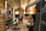 Luxury chalet gym with wooden features and state-of-the-art equipment.