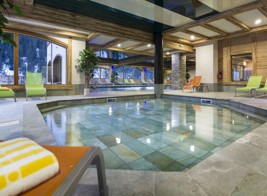 This luxurious hotel boasts a stunning indoor pool and jacuzzi area, perfect for relaxation and rejuvenation.