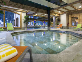 This luxurious hotel boasts a stunning indoor pool and jacuzzi area, perfect for relaxation and rejuvenation.
