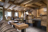 This stunning hotel lobby boasts a rustic-chic design with exposed wooden beams, a cozy fireplace, and comfortable seating areas.