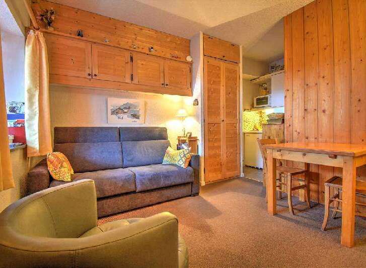 Cozy chalet apartment featuring a comfortable sofa bed, perfect for a relaxing stay.