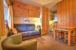 Cozy chalet apartment featuring a comfortable sofa bed, perfect for a relaxing stay.