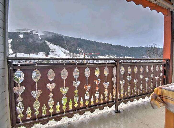 Enjoy breathtaking mountain views from your private balcony, featuring an intricately designed railing.