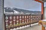 Enjoy breathtaking mountain views from your private balcony, featuring an intricately designed railing.