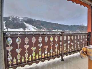 Enjoy breathtaking mountain views from your private balcony, featuring an intricately designed railing.