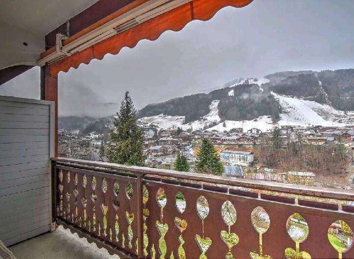 This stunning property boasts breathtaking views of snow-capped mountains and a charming town from its private balcony.